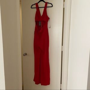 Bebe red jumpsuit, never worn with tags
